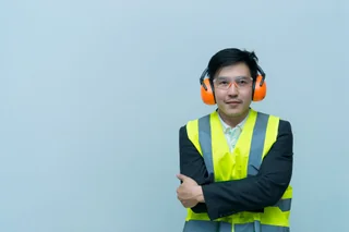 A person wearing clear protective safety glasses