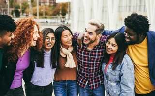 A diverse group of friends laughing together outdoors